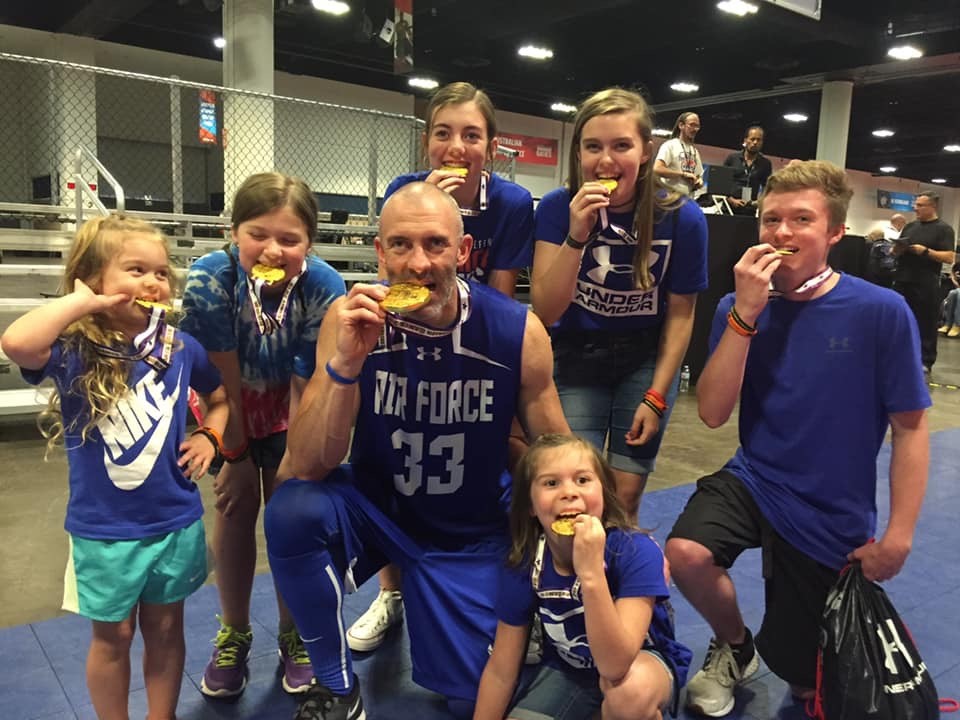 Tech. Sgt. Josh Smith (Ret.) and his six children pose with his DOD Warrior Games medals. Photo courtesy of Josh and Michelle Smith.